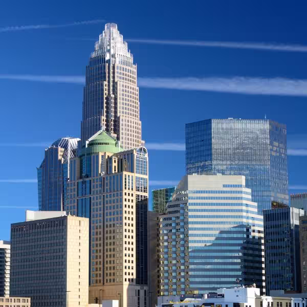 Image of skyscrapers in uptown Charlotte, North Carolina amidst a blue sky